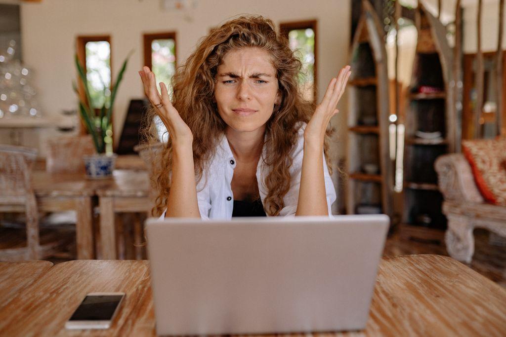 Mujer frustrada mientras usa una laptop